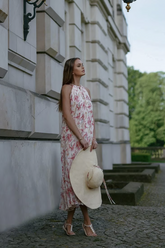 a lady in a pink floral print dress